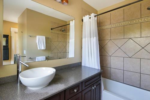 a bathroom with a white bowl sink and a shower at Home with Garage, Hot Tub, near OSU & Short North in Columbus