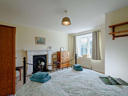a bedroom with a bed with two blue pillows on it at 2 bed in Strontian CA046 in Scotstown
