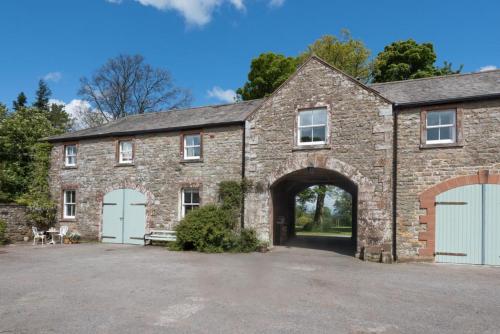 a large brick building with an archway at 2 Bed in Boltongate SZ396 in Mealsgate