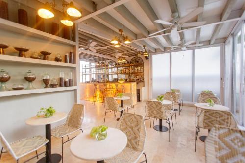 a restaurant with tables and chairs in a room at Sol de Alba Hotel Boutique in Cartagena de Indias