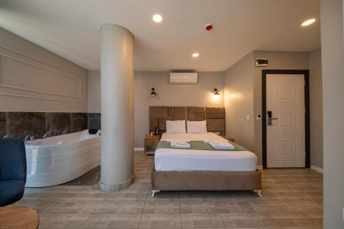 a bedroom with a large bed and a bath tub at Casa Nova Hotel in Istanbul