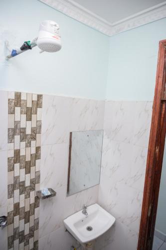 a bathroom with a sink and a mirror at SpringStone executive apartment A15 in Ongata Rongai 