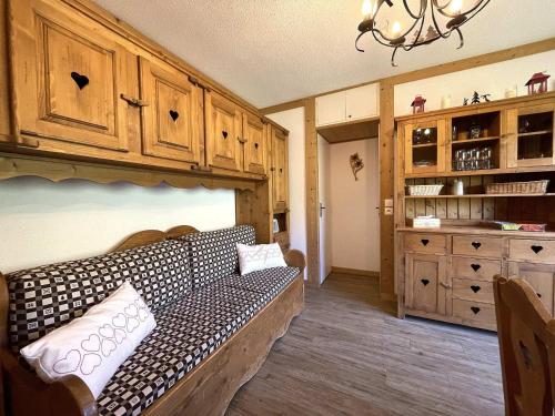 - un salon avec un canapé et des placards en bois dans l'établissement Appartement confort 6 pers, belle vue montagne, ski-in ski-out aux Menuires - FR-1-452-96, aux Menuires