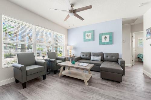 a living room with a couch and chairs and a table at Sun and Sea By Beachside Management in Siesta Key