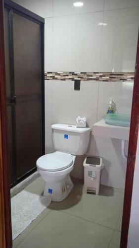 a bathroom with a toilet and a sink at Liahs tortuguero in Tortuguero
