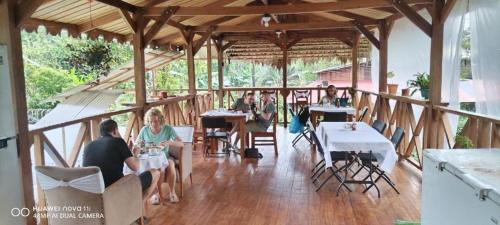 a group of people sitting at tables in a restaurant at Liahs tortuguero in Tortuguero