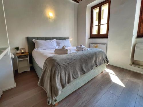 a bedroom with a bed with two stuffed animals on it at Tuscany Old Town in Arezzo