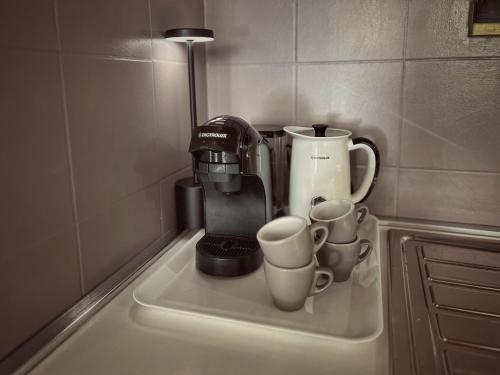a counter with cups and a coffee maker on it at Tuscany Old Town in Arezzo