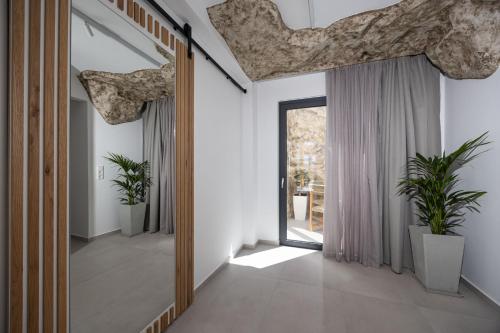 a hallway with a large mirror in a house at Bonsai Luxury Villas Naxos in Naxos Chora