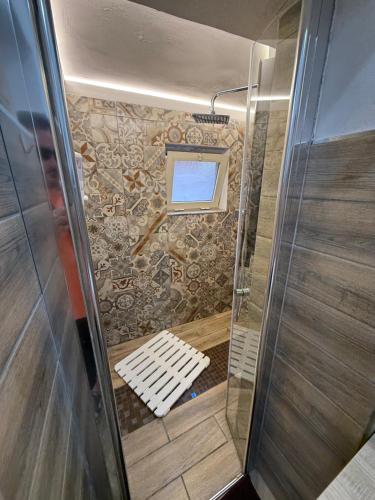 un piccolo bagno con doccia e panca di Loft Largo Gloria locazione turistica a Messina