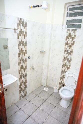 a bathroom with a toilet and a sink at SpringStone executive apartment A4 in Ongata Rongai 
