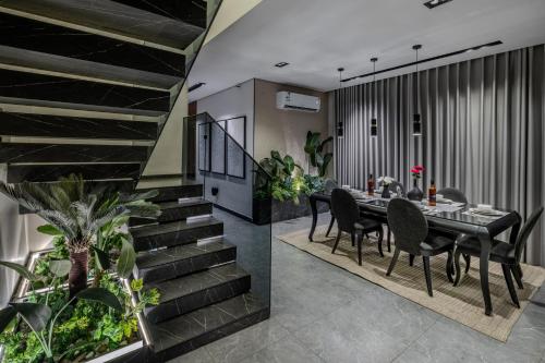 a dining room with a table and chairs and stairs at Super Luxury SweetHome in Medina