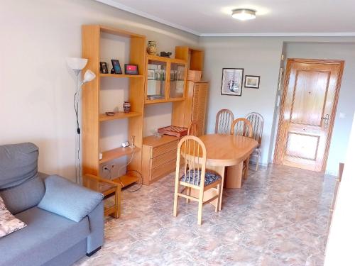 a living room with a table and a couch at Van-Dyck, ESC-4, 6-24 PK 18 in Cullera