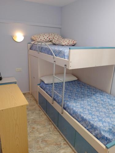 two bunk beds in a room with a desk at Van-Dyck, ESC-4, 6-24 PK 18 in Cullera