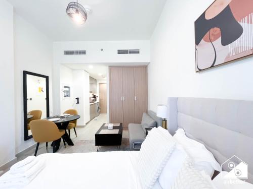 a bedroom with a bed and a living room at Urban Charm Studio with Balcony in Azizi Riviera in Dubai
