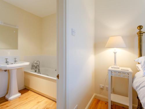 a bathroom with a sink and a bath tub at 3 bed in Achnasheen CA120 in Inveralligin