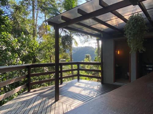 a wooden deck with a pergola on a house at Chalé Domingos Martins in Domingos Martins