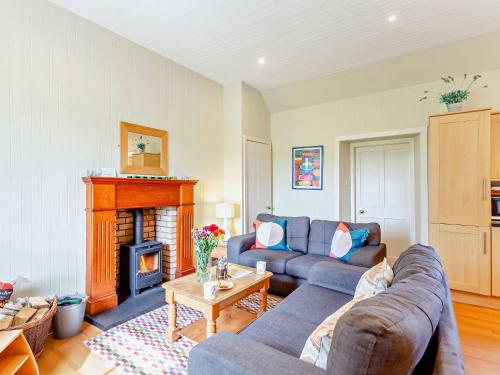 a living room with a couch and a fireplace at 2 Bed in Conon Bridge CA387 in Cononbridge