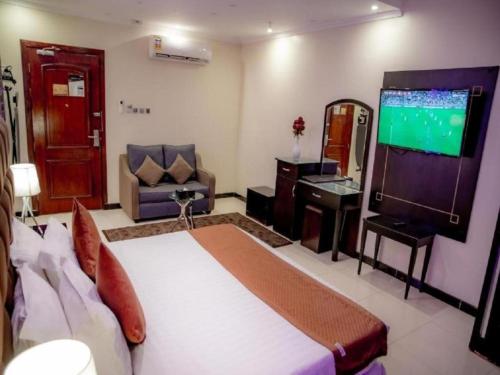 a hotel room with a bed and a flat screen tv at فندق السلطان ان Alsultan Inn Hotel in Jazan