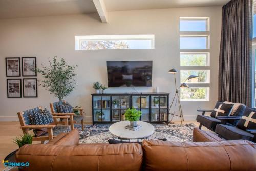 a living room with a couch and a table at Gathering Place Hot Tub Game rooms in Orem