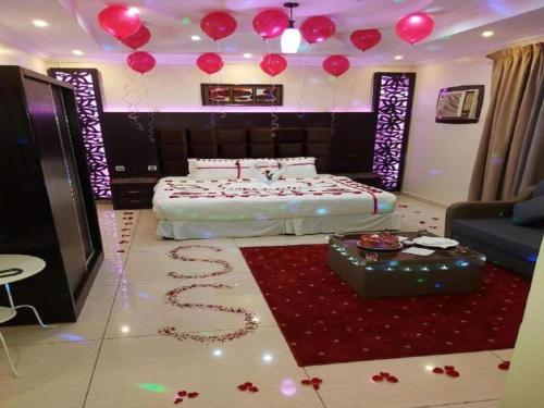 a bedroom with a bed with red balloons on the floor at فندق السلطان ان Alsultan Inn Hotel in Jazan