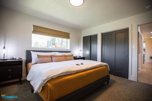 a bedroom with a large bed and a window at Gathering Place Hot Tub Game rooms in Orem