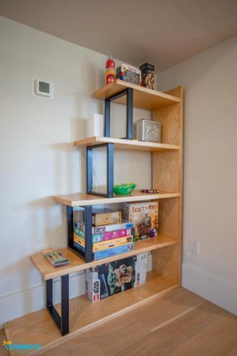 a book shelf filled with books in a room at Gathering Place Hot Tub Game rooms in Orem