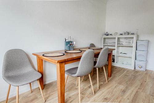 a dining room table with four chairs in a room at Ferienhaus Arina in Bad Bertrich