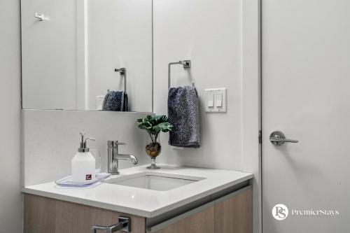 a bathroom with a sink and a mirror at Executive Suite on the 31st Floor Queen Bed with Sofa Bed Free Parking BBQ in Calgary