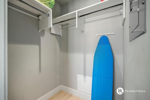 a bathroom with a blue surfboard hanging on the wall at Executive Suite on the 31st Floor Queen Bed with Sofa Bed Free Parking BBQ in Calgary