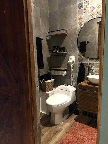 a bathroom with a toilet and a sink at Don Quijote de Tampico in Tampico