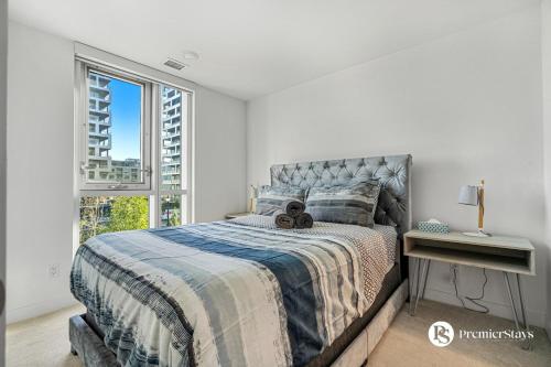 a bedroom with a large bed and a window at Luxury Spacious 2 Bedroom Apartment at The Radius in Calgary