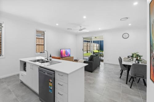 a kitchen and living room with a couch and a table at Spacious 4BR Home Great Area close to everything in Ripley