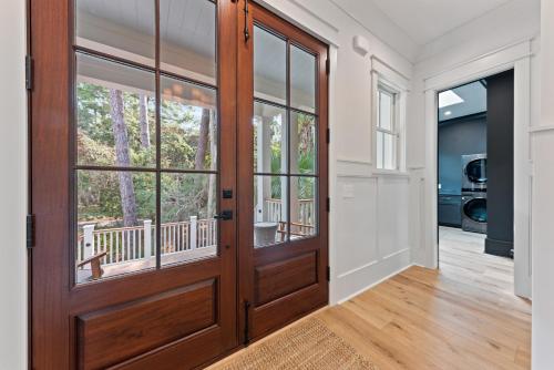 a large wooden door in a room with a balcony at Stunning New Home with Private Pool in Seabrook Island