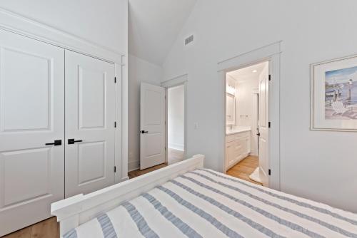 a white bedroom with white cabinets and a bed at Stunning New Home with Private Pool in Seabrook Island