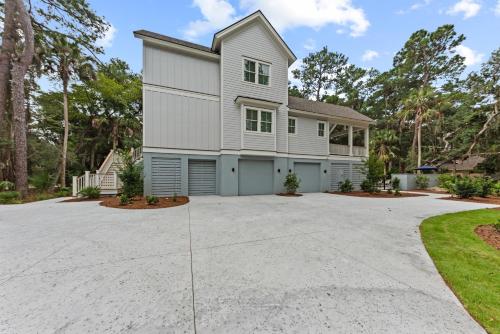 a house with a large driveway at Stunning New Home with Private Pool in Seabrook Island