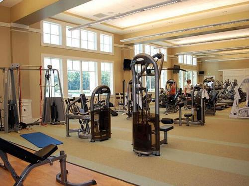 a gym with a lot of treadmills and machines at Stunning New Home with Private Pool in Seabrook Island