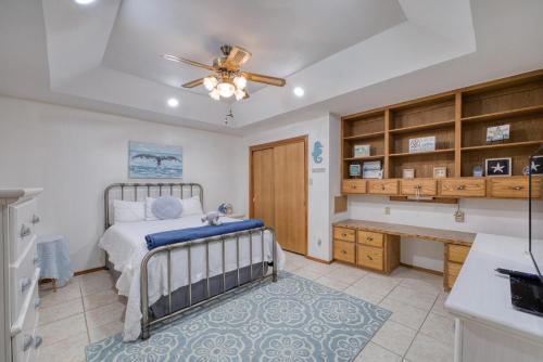 a bedroom with a bed and a desk at Bright Pharr Getaway Spacious Family Home w Garage and WiFi in Pharr