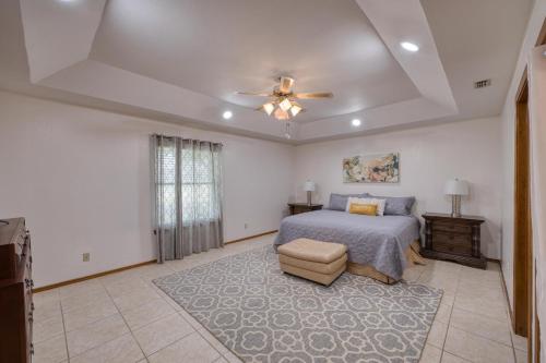 a bedroom with a bed and a ceiling fan at Bright Pharr Getaway Spacious Family Home w Garage and WiFi in Pharr