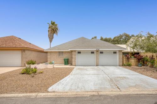 a house with a palm tree and a driveway at Bright Pharr Getaway Spacious Family Home w Garage and WiFi in Pharr