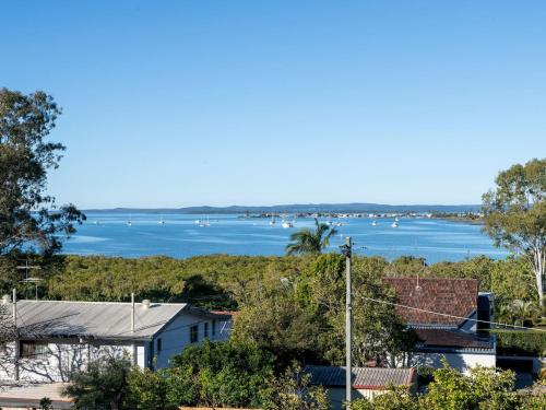 a view of the water from a house at Coastal Family Escape with Pool Balcony and Bay Views in Ormiston