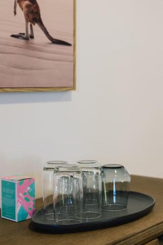 a group of wine glasses sitting on top of a table at Spacious Family Retreat in Peaceful Parkinson in Browns Plains