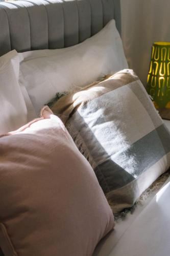 a person laying on a bed with pillows at Spacious Family Retreat in Peaceful Parkinson in Browns Plains