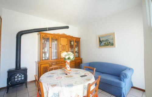 a living room with a table and a blue couch at Lovely Home In Arnasco With Wifi in Arnasco