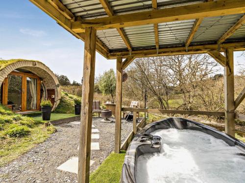 a hot tub in a garden with a wooden roof at 1 Bed in Llanidloes 81415 in Van