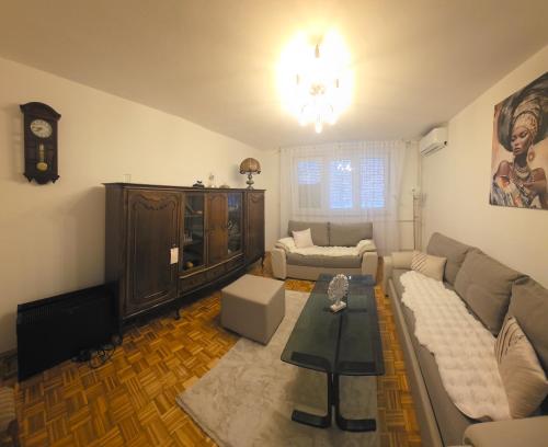 a living room with a couch and a table at Apartman BELLA in Doboj