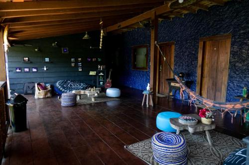 a living room with blue walls and a wooden floor at Casa Miranda in Trindade