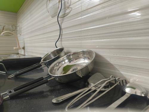 two mixing bowls on a counter in a kitchen at EESHA's Villa - Rameswaram in Rāmeswaram