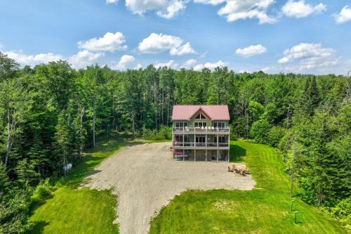 an aerial view of a house in the woods at Rustic 3-Story Pittsburg Cabin with Lake and Mtn Views in Pittsburg