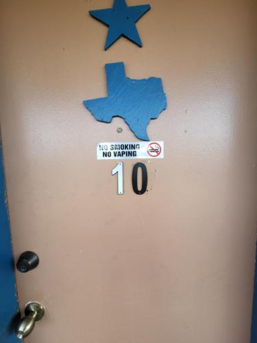 a door with a no smoking sign on it at Hill Country Lodge and Mini Storages in Buchanan Dam